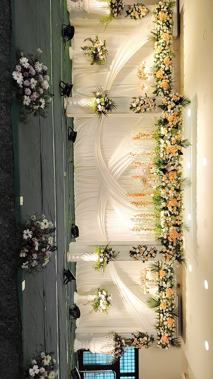 Ring ceremony decoration in Hyderabad with a flower wall and lit couple seating
