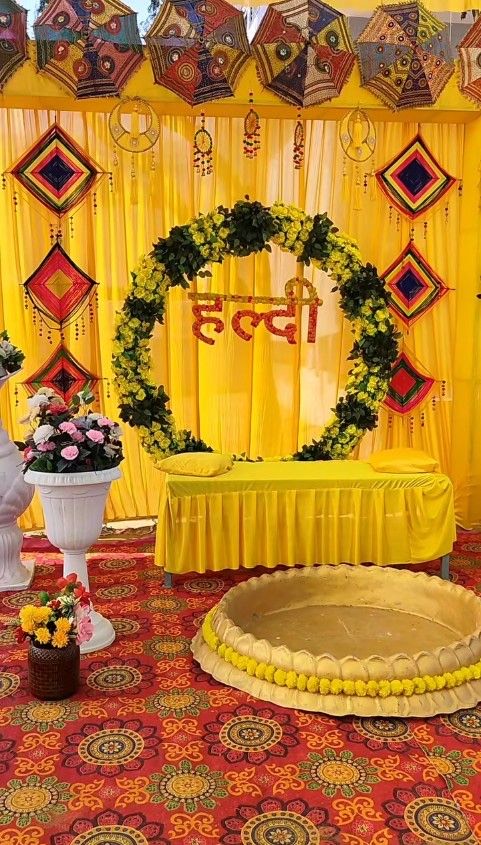 Haldi ceremony decoration in Hyderabad with yellow drapes and marigold flower strings