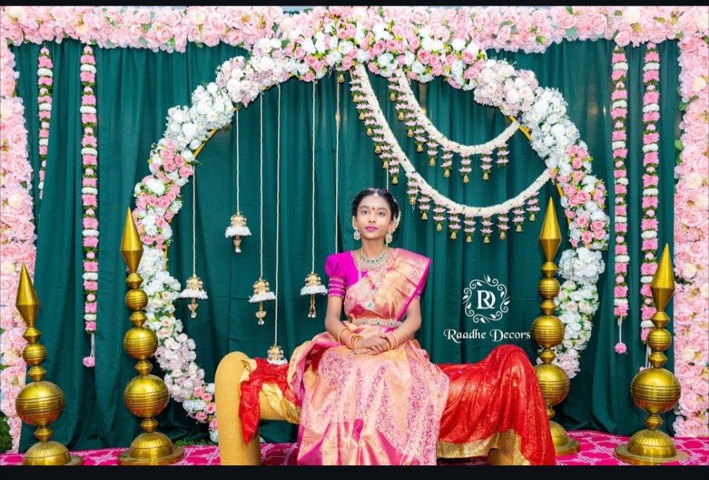 Half saree function decoration in Hyderabad with a pink and white floral stage