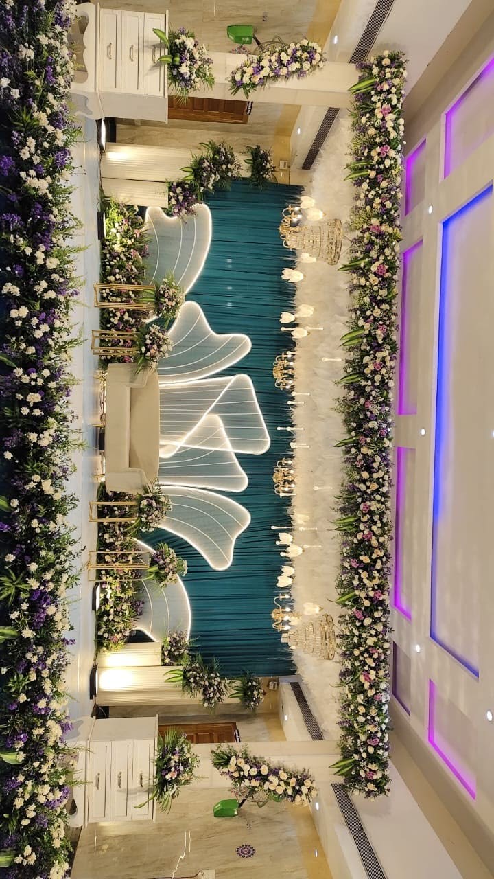 Wedding reception stage decoration in Hyderabad with a floral backdrop and decorated couple seating